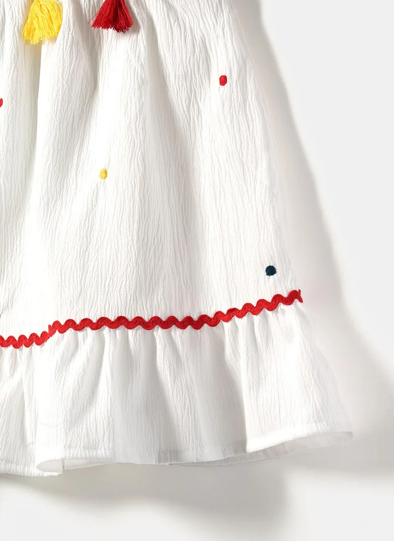 Nautinati  Girls' A-line Polka Dot Embroidered Dress with Multicolour Tassels & Smocked Neck for Women | Best Price UAE